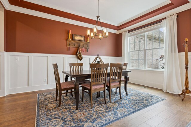 6013 Blackwell Ln, Franklin, TN 37064 - dining area with a decorative wall, a chandelier, ornamental molding, wainscoting, and wood finished floors