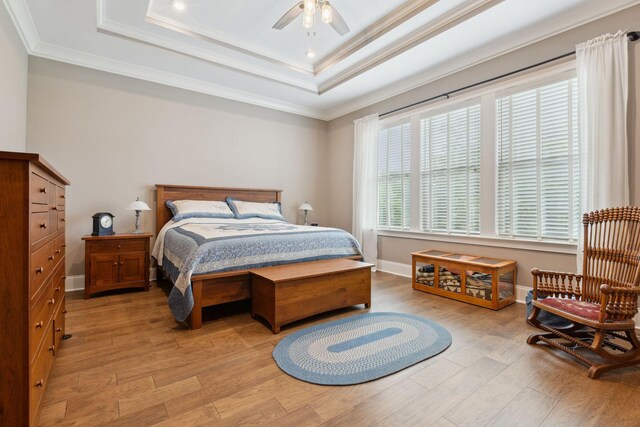 6013 Blackwell Ln, Franklin, TN 37064 - bedroom with light wood-style flooring, a tray ceiling, ornamental molding, and a ceiling fan