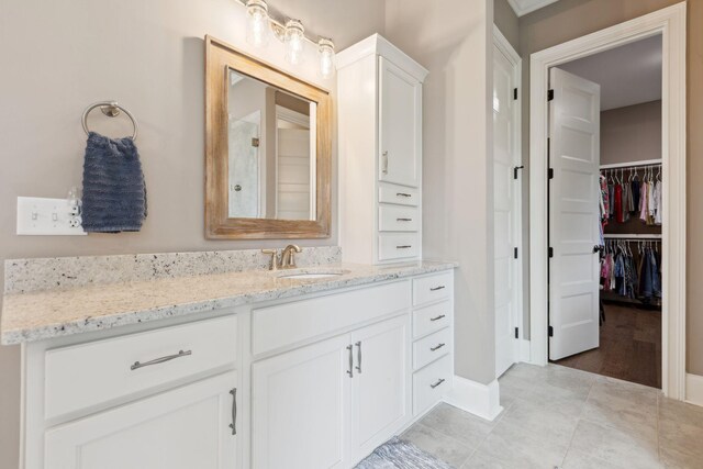 6013 Blackwell Ln, Franklin, TN 37064 - full bathroom featuring vanity, a spacious closet, and tile patterned flooring