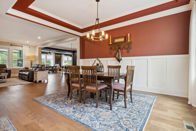 6013 Blackwell Ln, Franklin, TN 37064 - dining area with a decorative wall, a chandelier, ornamental molding, wood finished floors, and a wainscoted wall