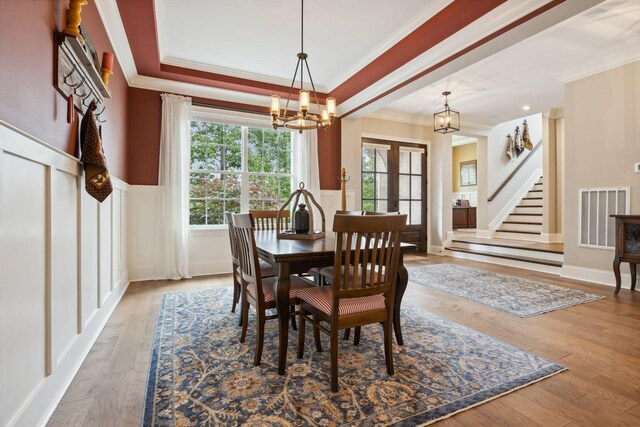 6013 Blackwell Ln, Franklin, TN 37064 - dining area with a chandelier, ornamental molding, french doors, wood finished floors, and wainscoting