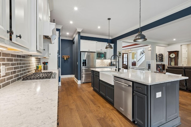 6013 Blackwell Ln, Franklin, TN 37064 - kitchen with appliances with stainless steel finishes, tasteful backsplash, white cabinets, ornamental molding, and recessed lighting