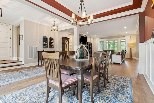 6013 Blackwell Ln, Franklin, TN 37064 - dining space with a chandelier, wood finished floors, ornamental molding, recessed lighting, and a tray ceiling