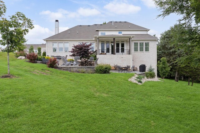 6013 Blackwell Ln, Franklin, TN 37064 - back of property featuring a patio, a chimney, and a lawn