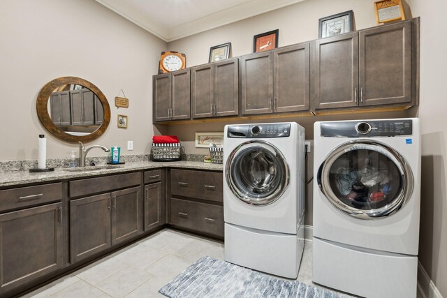 6013 Blackwell Ln, Franklin, TN 37064 - laundry room with cabinet space, washing machine and dryer, light tile patterned flooring, and crown molding