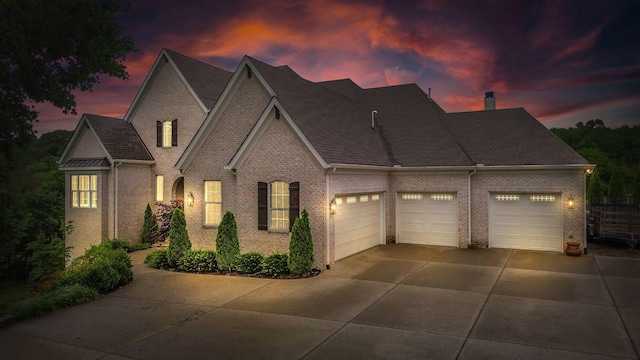 6013 Blackwell Ln, Franklin, TN 37064 - view of front of house featuring brick siding, a garage, driveway, and a shingled roof