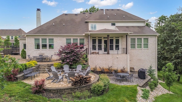 6013 Blackwell Ln, Franklin, TN 37064 - rear view of property featuring a patio area, brick siding, and a fire pit