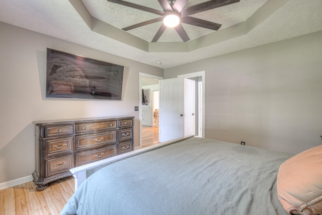 168 N Wagon Trl, Murfreesboro, TN 37128 - bedroom with a raised ceiling, light wood-style flooring, and a ceiling fan