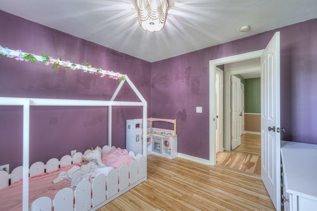 168 N Wagon Trl, Murfreesboro, TN 37128 - unfurnished bedroom featuring wood finished floors and a chandelier