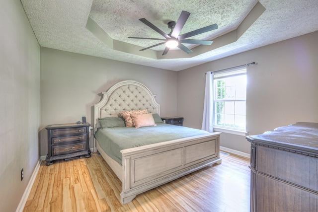 168 N Wagon Trl, Murfreesboro, TN 37128 - bedroom with a raised ceiling, a textured ceiling, light wood-style floors, and a ceiling fan