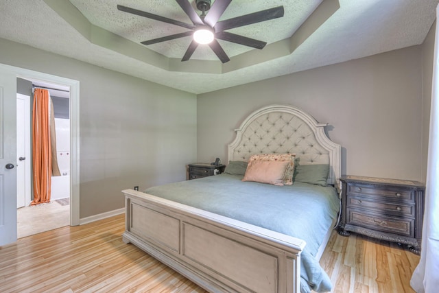 168 N Wagon Trl, Murfreesboro, TN 37128 - bedroom featuring a tray ceiling, light wood finished floors, a textured ceiling, and ceiling fan