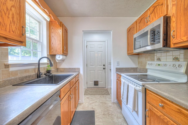 168 N Wagon Trl, Murfreesboro, TN 37128 - kitchen featuring appliances with stainless steel finishes, tasteful backsplash, brown cabinetry, light countertops, and a textured ceiling
