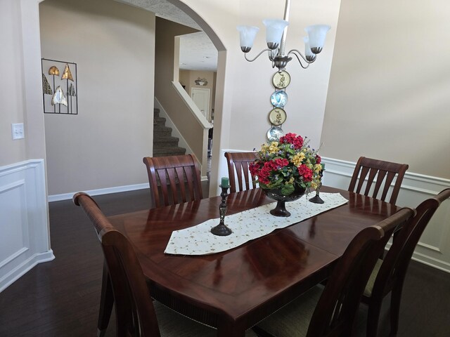 1736 Bellamy Ln, Murfreesboro, TN 37128 - dining space featuring wood finished floors, arched walkways, a chandelier, and stairway