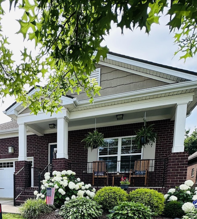 2141 Kirkwall Dr, Nolensville, TN 37135 - view of side of home with brick siding, a porch, and an attached garage