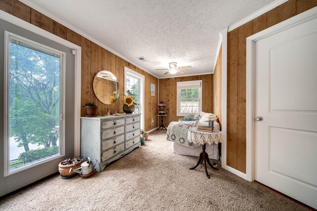 554 Hickman Shores Rd, Dover, TN 37058 - bedroom featuring crown molding, carpet floors, a textured ceiling, wood walls, and ceiling fan