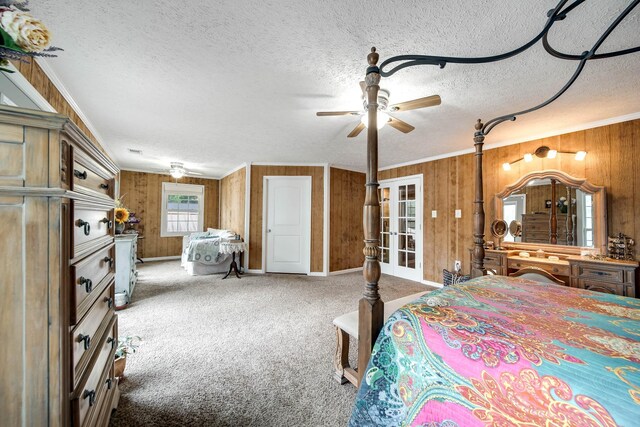 554 Hickman Shores Rd, Dover, TN 37058 - carpeted bedroom with ornamental molding, wood walls, a textured ceiling, and french doors