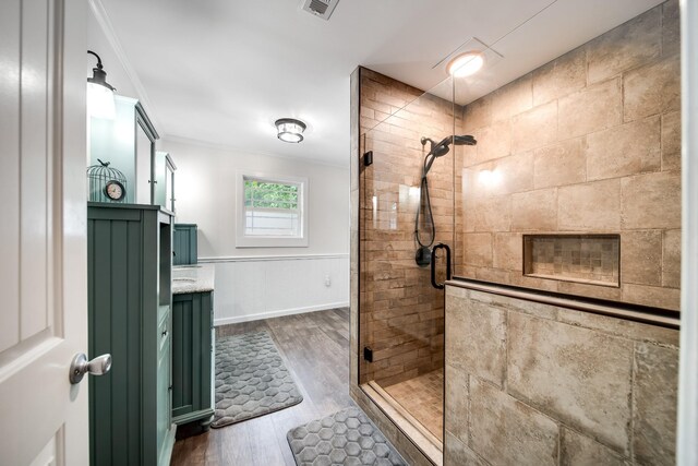 554 Hickman Shores Rd, Dover, TN 37058 - full bath with ornamental molding, a shower stall, vanity, and wood finished floors