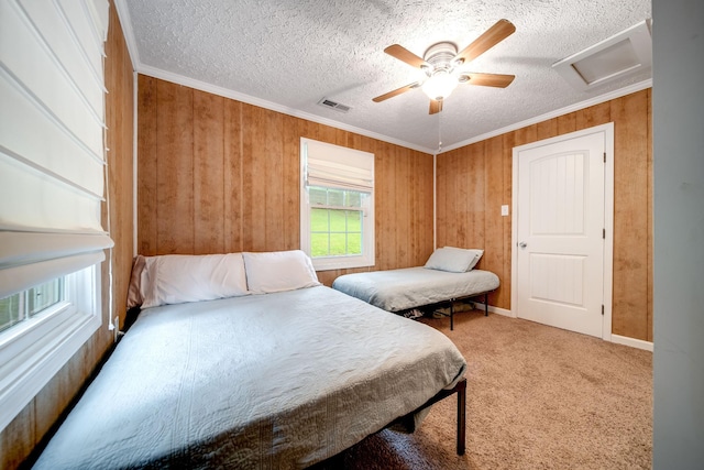 554 Hickman Shores Rd, Dover, TN 37058 - bedroom featuring attic access, crown molding, a textured ceiling, wood walls, and carpet floors