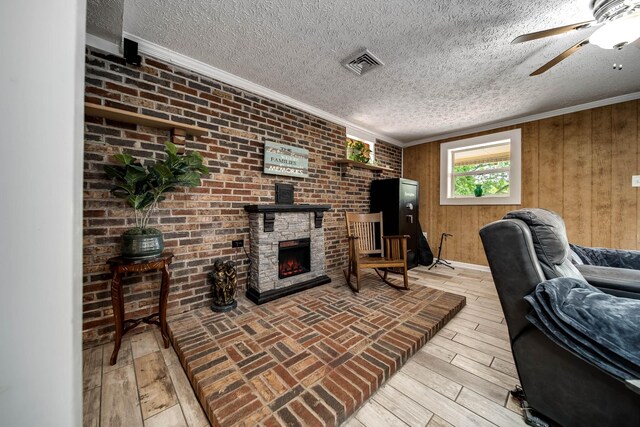 554 Hickman Shores Rd, Dover, TN 37058 - office area featuring ornamental molding, a textured ceiling, a ceiling fan, a fireplace, and light wood-style flooring