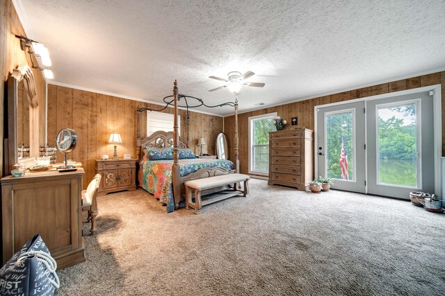 554 Hickman Shores Rd, Dover, TN 37058 - bedroom with access to outside, wood walls, carpet flooring, a textured ceiling, and ornamental molding