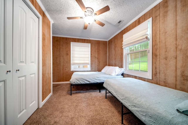 554 Hickman Shores Rd, Dover, TN 37058 - bedroom with carpet, wood walls, a textured ceiling, ceiling fan, and ornamental molding