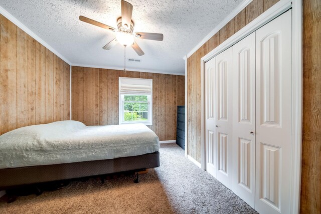 554 Hickman Shores Rd, Dover, TN 37058 - bedroom with a textured ceiling, a closet, carpet, ceiling fan, and wood walls
