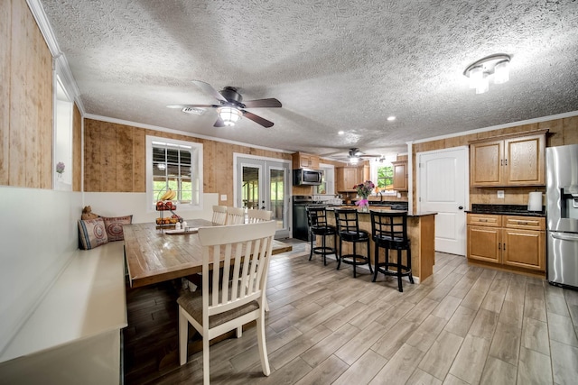 554 Hickman Shores Rd, Dover, TN 37058 - dining space with crown molding, light wood-style floors, a ceiling fan, a textured ceiling, and french doors
