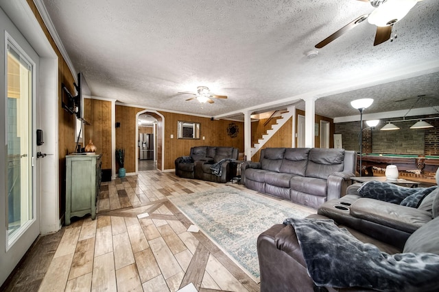 554 Hickman Shores Rd, Dover, TN 37058 - living room featuring a ceiling fan, a textured ceiling, wood finished floors, billiards table, and arched walkways