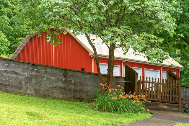 554 Hickman Shores Rd, Dover, TN 37058 - view of side of home featuring a garage, an outbuilding, and a lawn