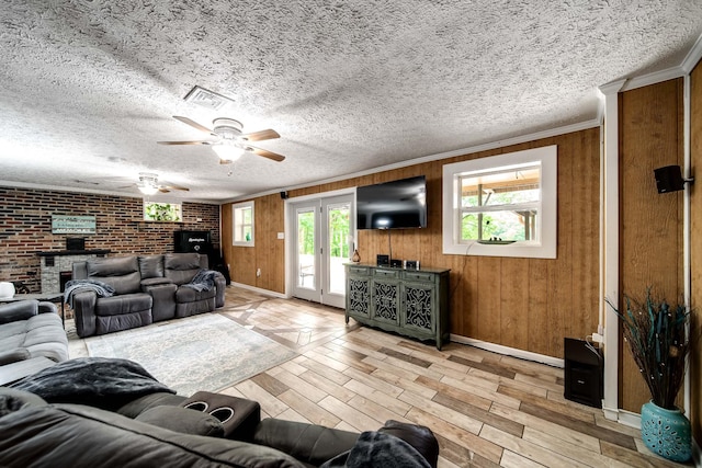 554 Hickman Shores Rd, Dover, TN 37058 - living room with light wood finished floors, ceiling fan, plenty of natural light, wood walls, and ornamental molding