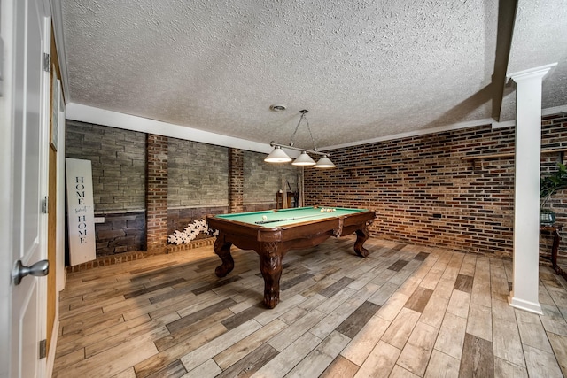 554 Hickman Shores Rd, Dover, TN 37058 - recreation room featuring a textured ceiling, wood finished floors, decorative columns, pool table, and brick wall