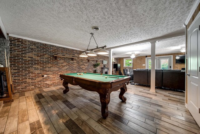 554 Hickman Shores Rd, Dover, TN 37058 - recreation room with brick wall, light wood-style flooring, pool table, a textured ceiling, and ornate columns