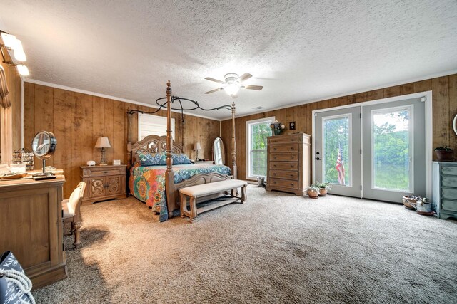 554 Hickman Shores Rd, Dover, TN 37058 - carpeted bedroom featuring access to outside, wooden walls, a textured ceiling, ornamental molding, and a ceiling fan