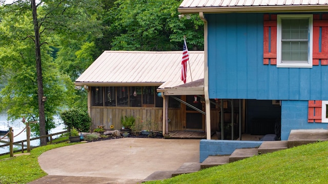 554 Hickman Shores Rd, Dover, TN 37058 - view of front of home with a sunroom, a patio area, and a metal roof