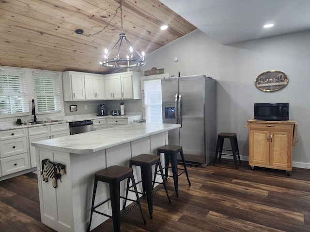 200 Church St, Loretto, TN 38469 - kitchen featuring stainless steel appliances, dark wood-type flooring, wooden ceiling, a kitchen bar, and white cabinets