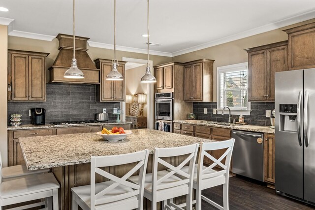 318 Finnhorse Ln, Franklin, TN 37064 - kitchen with stainless steel appliances, crown molding, recessed lighting, a kitchen island, and backsplash