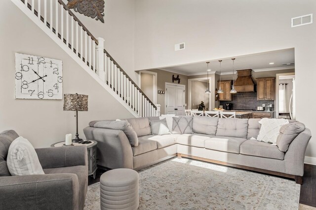 318 Finnhorse Ln, Franklin, TN 37064 - living room with stairway, crown molding, a high ceiling, and recessed lighting