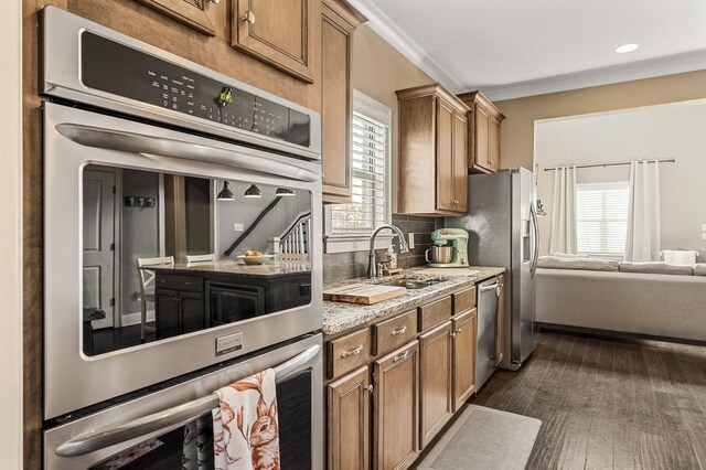 318 Finnhorse Ln, Franklin, TN 37064 - kitchen with appliances with stainless steel finishes, brown cabinetry, dark wood-type flooring, and backsplash
