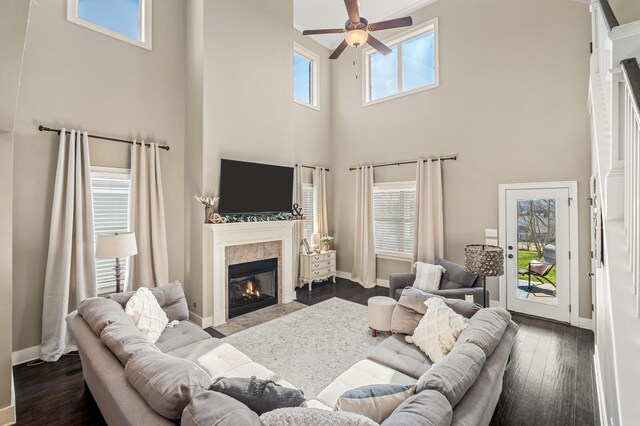 318 Finnhorse Ln, Franklin, TN 37064 - living area with ceiling fan, a towering ceiling, a tile fireplace, and dark wood-style floors