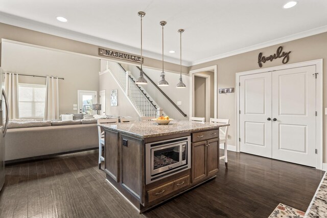 318 Finnhorse Ln, Franklin, TN 37064 - kitchen with stainless steel microwave, recessed lighting, dark brown cabinetry, dark wood-style floors, and light stone counters