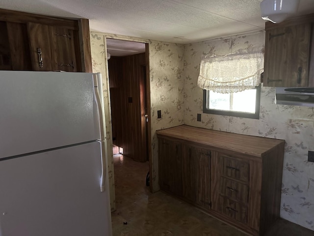 4719 Bogard Rd, Cosby, TN 37722 - kitchen with freestanding refrigerator, a textured ceiling, and wallpapered walls