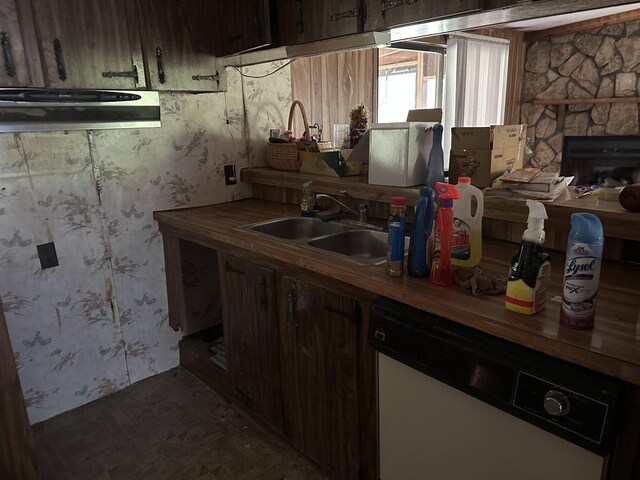 4719 Bogard Rd, Cosby, TN 37722 - kitchen with white dishwasher, extractor fan, wallpapered walls, and a stone fireplace
