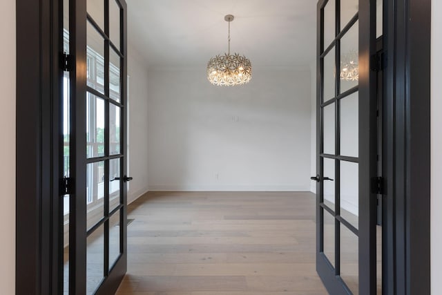 7312 Walker Rd, Fairview, TN 37062 - spare room with french doors, a chandelier, and wood finished floors