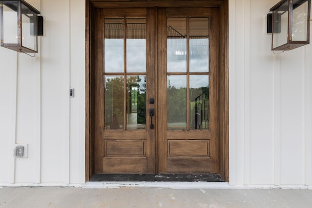 7312 Walker Rd, Fairview, TN 37062 - view of exterior entry featuring french doors and board and batten siding