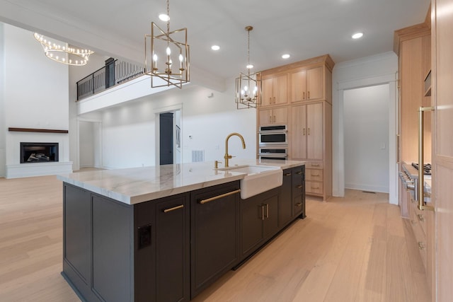 7312 Walker Rd, Fairview, TN 37062 - kitchen with a chandelier, light brown cabinets, cooktop, a kitchen island with sink, and recessed lighting