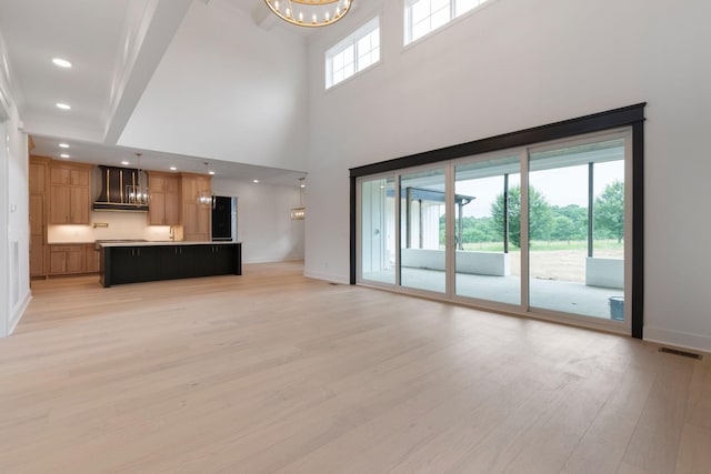 7312 Walker Rd, Fairview, TN 37062 - unfurnished living room with light wood-style flooring, a chandelier, recessed lighting, and a high ceiling