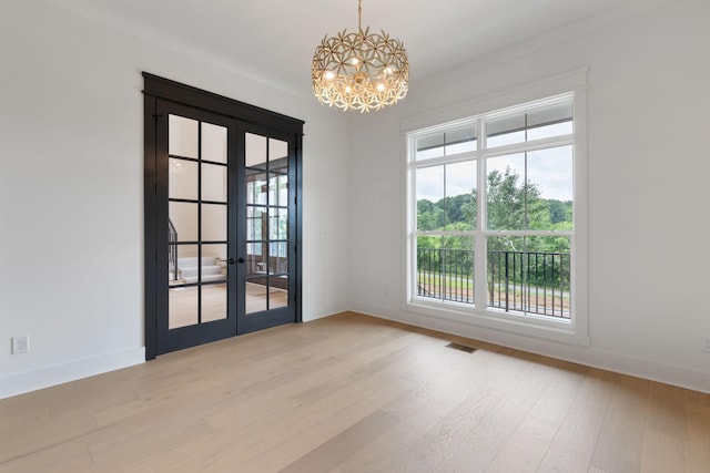 7312 Walker Rd, Fairview, TN 37062 - spare room featuring french doors, a chandelier, wood finished floors, and ornamental molding