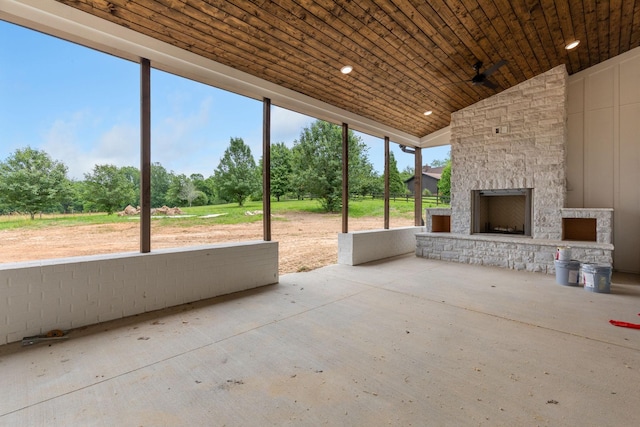 7312 Walker Rd, Fairview, TN 37062 - unfurnished sunroom with an outdoor stone fireplace, lofted ceiling, view of wooded area, and ceiling fan