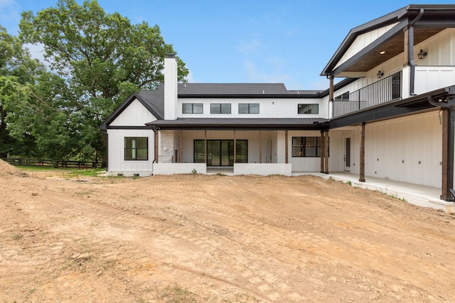 7312 Walker Rd, Fairview, TN 37062 - back of property featuring a chimney, a balcony, and board and batten siding