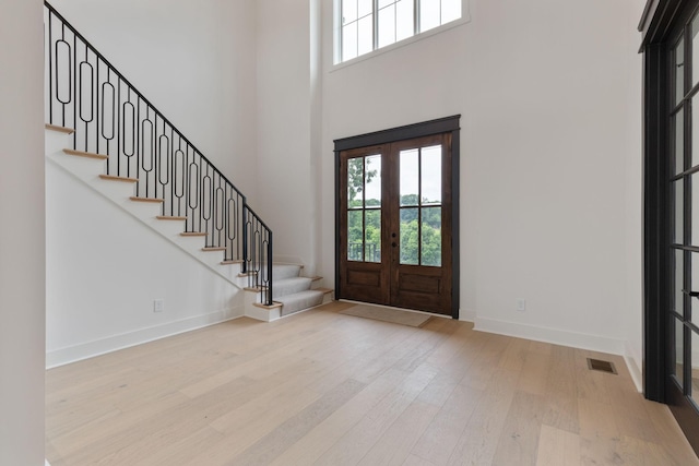 7312 Walker Rd, Fairview, TN 37062 - foyer featuring healthy amount of natural light, french doors, wood finished floors, stairs, and a towering ceiling